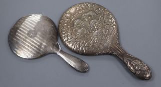 An Edwardian 'Reynolds Angel's' decorated silver hand mirror and one other silver mirror.