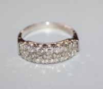 An 18ct white metal and diamond set double row half hoop ring, size M/N.