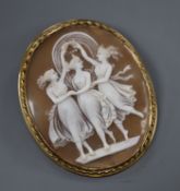 A yellow metal mounted oval cameo brooch carved with the Three Graces, 56mm.