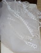 A 1930's white satin wedding dress and later veil