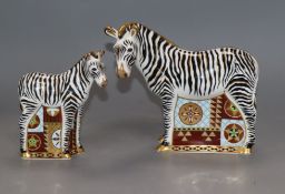 Two Royal Crown Derby paperweights of a zebra and a zebra baby, gold stoppers
