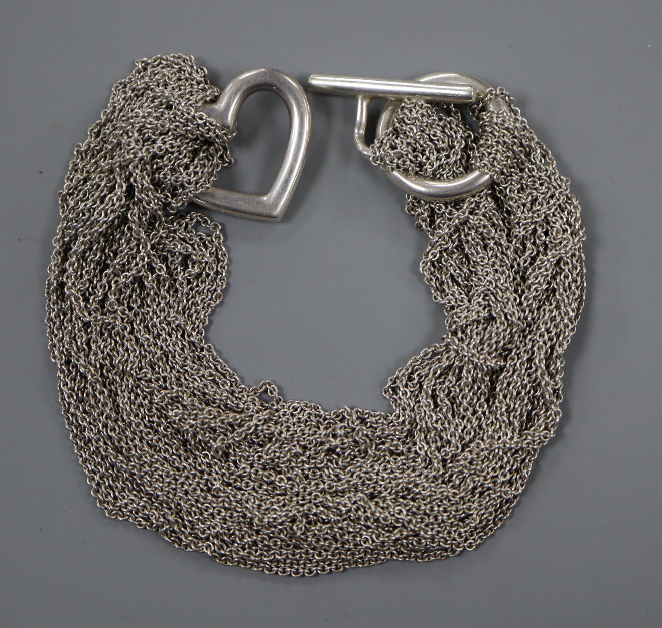 A Tiffany & Co sterling chain mesh link necklace with central heart motif, 40cm.