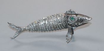 A Spanish white metal articulated model of a fish with green cabochon eyes, 12.4cm.