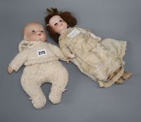 An A.M. open mouthed bisque headed doll and a baby doll