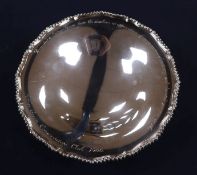 A circular silver presentation pedestal bowl, having gadrooned edge and inscription to rim,