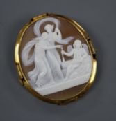 An early 20th century yellow metal mounted oval cameo brooch, carved with Cupid, Venus and Psyche,