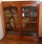 A Victorian walnut glazed bookcase W.88cm