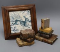 A 'Hare' china teapot stand in wooden frame and eight marble books
