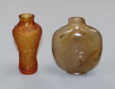 A Chinese agate snuff bottle and an amber glass snuff bottle