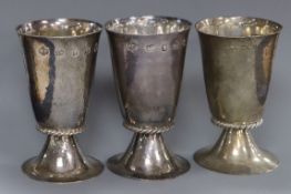A pair of QE II hammered silver goblets, H. Phillips, London, 1952 and one other silver goblet, 11