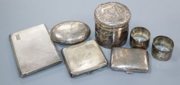 Three silver cigarette cases, a pair of silver napkin rings, a William Comyns embossed silver pot