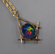 A modern yellow metal and black opal doublet pendant, on a 9ct chain, pendant 31mm.