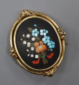 A yellow metal mounted Victorian pietra dura oval brooch, decorated with flowers and etched en verso
