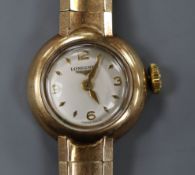 A lady's Longines 9ct gold wrist watch on flexible bracelet.
