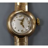 A lady's Longines 9ct gold wrist watch on flexible bracelet.