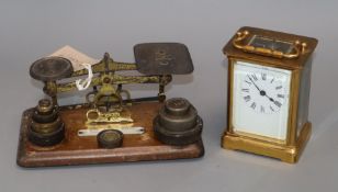 A brass carriage timepiece and a set of postal scales and weights