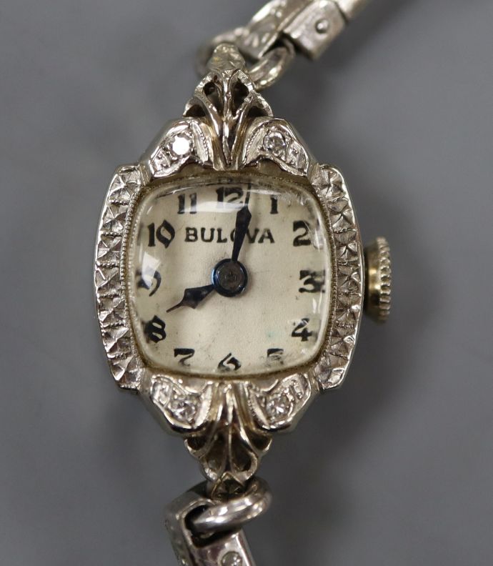 A lady's 14k white metal and diamond set Bulova manual wind cocktail watch.