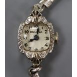 A lady's 14k white metal and diamond set Bulova manual wind cocktail watch.