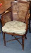 A set of eight Regency style mahogany chairs, with caned backs and sides and green squab seats