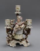 A Sitzendorf porcelain three branch candelabra, decorated with flowers surrounding a girl height