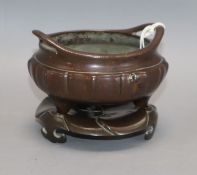 A Chinese bronze tripod censer and stand