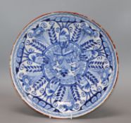 An 18th century English Delft blue and white charger with foliate decoration diameter 30cm