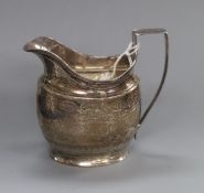 A George III silver cream jug, London, 1803, height 10cm.