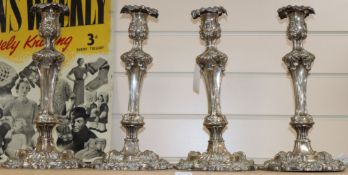 A set of four rococco plated candlesticks height 32cm