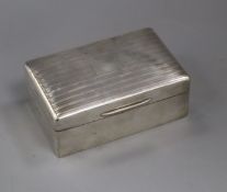 A George V silver cigarette box, Robert Pringle & Sons, London, 1934, 14cm.