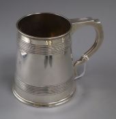 A George V silver mug with reeded bands, by Elkington & Co, Birmingham, 1913, 11.2cm, 11 oz.