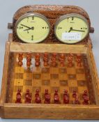 A bakelite travelling chess set and a snakeskin covered chess timer