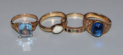 Four assorted 9ct gold and gem set dress rings including 'Dearest' ring and a white opal ring.