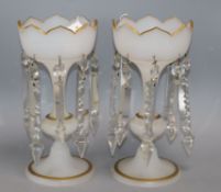 A pair of opaque white glass table lustres of tulip form, each on tapered knopped stem and
