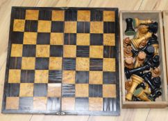 A Staunton pattern stained and natural boxwood chess set with folding chess board