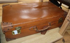 A tan leather suitcase width 70cm