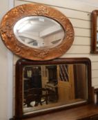 A copper wall mirror in the Arts and Crafts style W.76cm