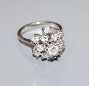 A modern 18ct white gold and diamond raised cluster ring, size O.
