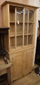 An early 19th century glazed pine narrow cabinet W.85cm