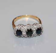 A yellow metal, sapphire and diamond set triple cluster ring, size O.