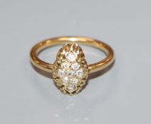 An early 20th century yellow metal and lozenge shaped diamond cluster ring, size M.