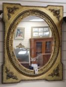 A giltwood and gesso rectangular wall mirror with oval plate