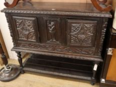 A 17th century style oak low cupboard W.118cm