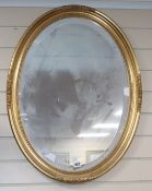 An oval gilt frame wall mirror H.78cm