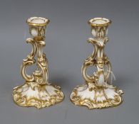 A pair of French gilt white glazed porcelain rococo scrollwork candlesticks height 16cm
