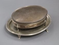 A George V silver trinket box and a silver teapot stand.