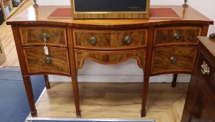 An Edwardian satinwood serpentine fronted mahogany sideboard, with tubular brass railed back W.