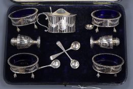 A cased George V Goldsmiths & Silversmiths seven piece Adam style silver condiment set.