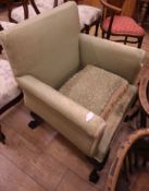 A green armchair, with claw feet