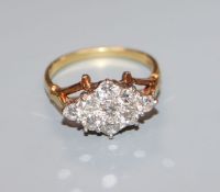 An 18ct and nine stone diamond set lozenge shaped ring, size N.