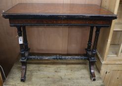 A Victorian ebony and amboyna card table W.91cm